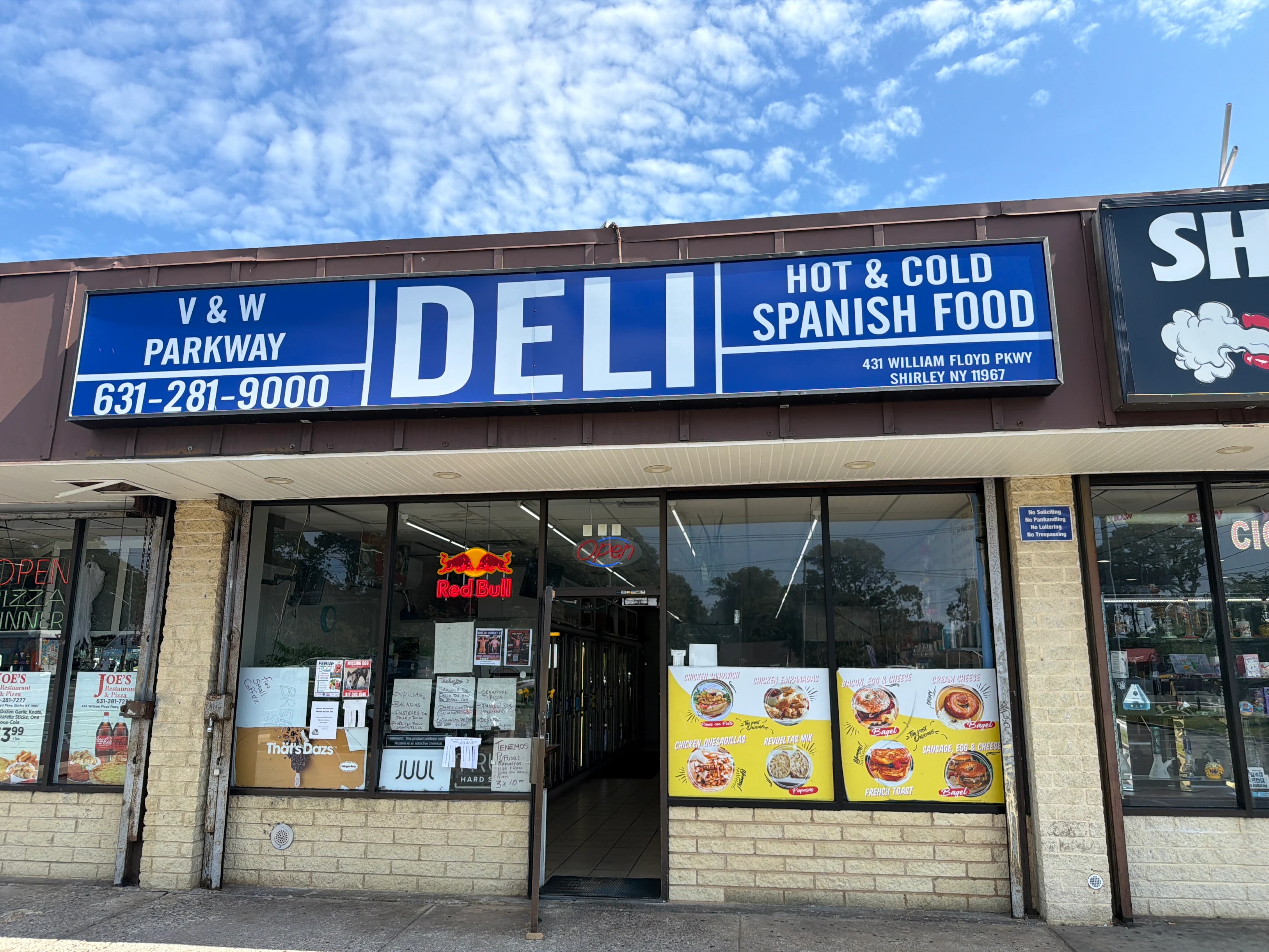 The blue V & W Parkway Deli storefront sign and entrance at 431 William Floyd Parkway